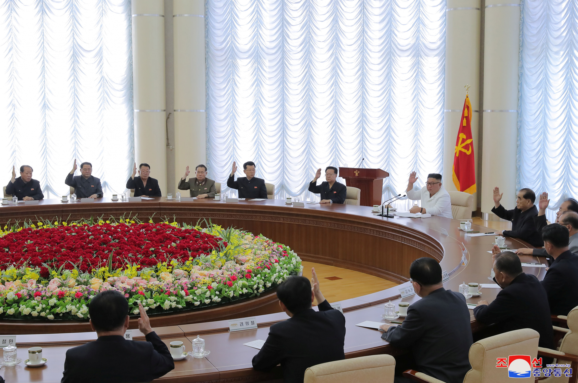 Kim jong-un, in white, leading a meeting photo released by the north korean state media last week 